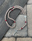Handmade Bethlehem Christmas rosary crafted in Fargo ND with red-gray wood beads and silver crucifix