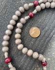 Close-up of red and light gray stained wooden beads on Bethlehem Christmas rosary