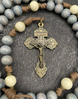 Lightweight rosary displayed against a soft, neutral background, featuring smooth, round beads, a sleek metallic crucifix, and a modest center medal with a sacred design, ideal for daily prayers, travel, or as a thoughtful religious gift.