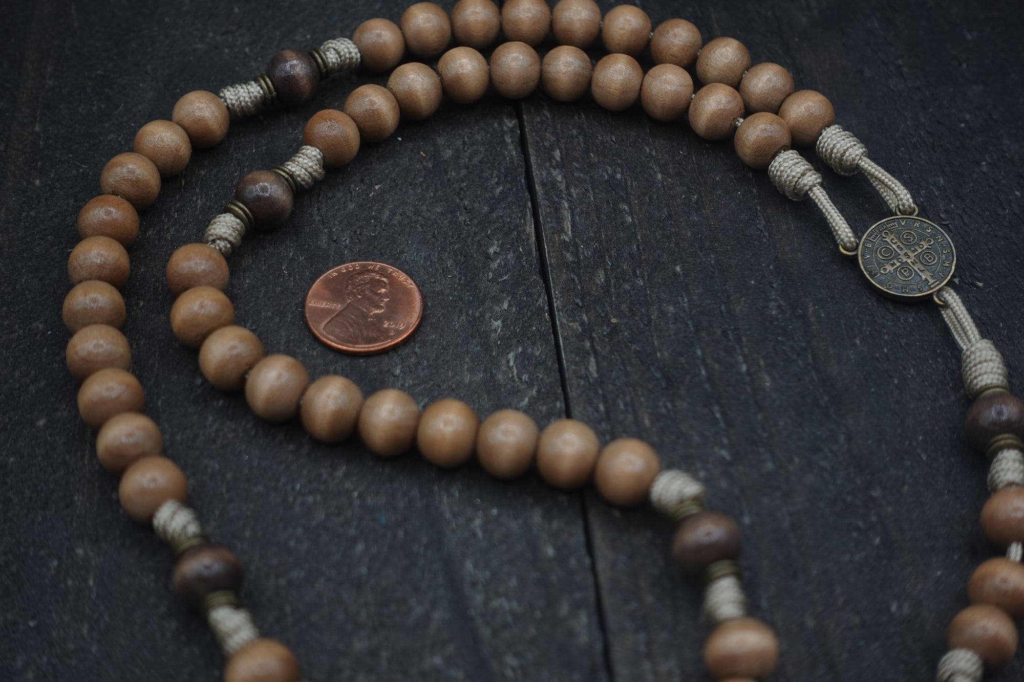 Road to Damascus paracord rosary with tan and gray-brown wooden beads and bronze St. Benedict crucifix, handcrafted in Fargo ND