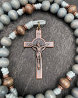 Close-up of a handcrafted Catholic rosary featuring durable silver beads, a detailed crucifix, and an ornate centerpiece, displayed on a white background.