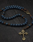 Durable paracord rosary built for daily prayer with bronze hardware and blue stained wooden beads