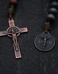 Close-up of bronze Pardon Crucifix and Miraculous Medal on handcrafted paracord rosary