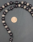 Wood bead detail showing unique tones and grain on handmade Memento Mori rosary