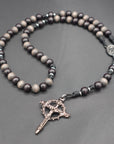 Handcrafted Memento Mori rosary for daily prayer featuring silver crucifix and gray-brown wood beads
