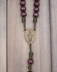 Close-up of bronze Miraculous Medal and paracord craftsmanship on handmade Mount of Olives rosary