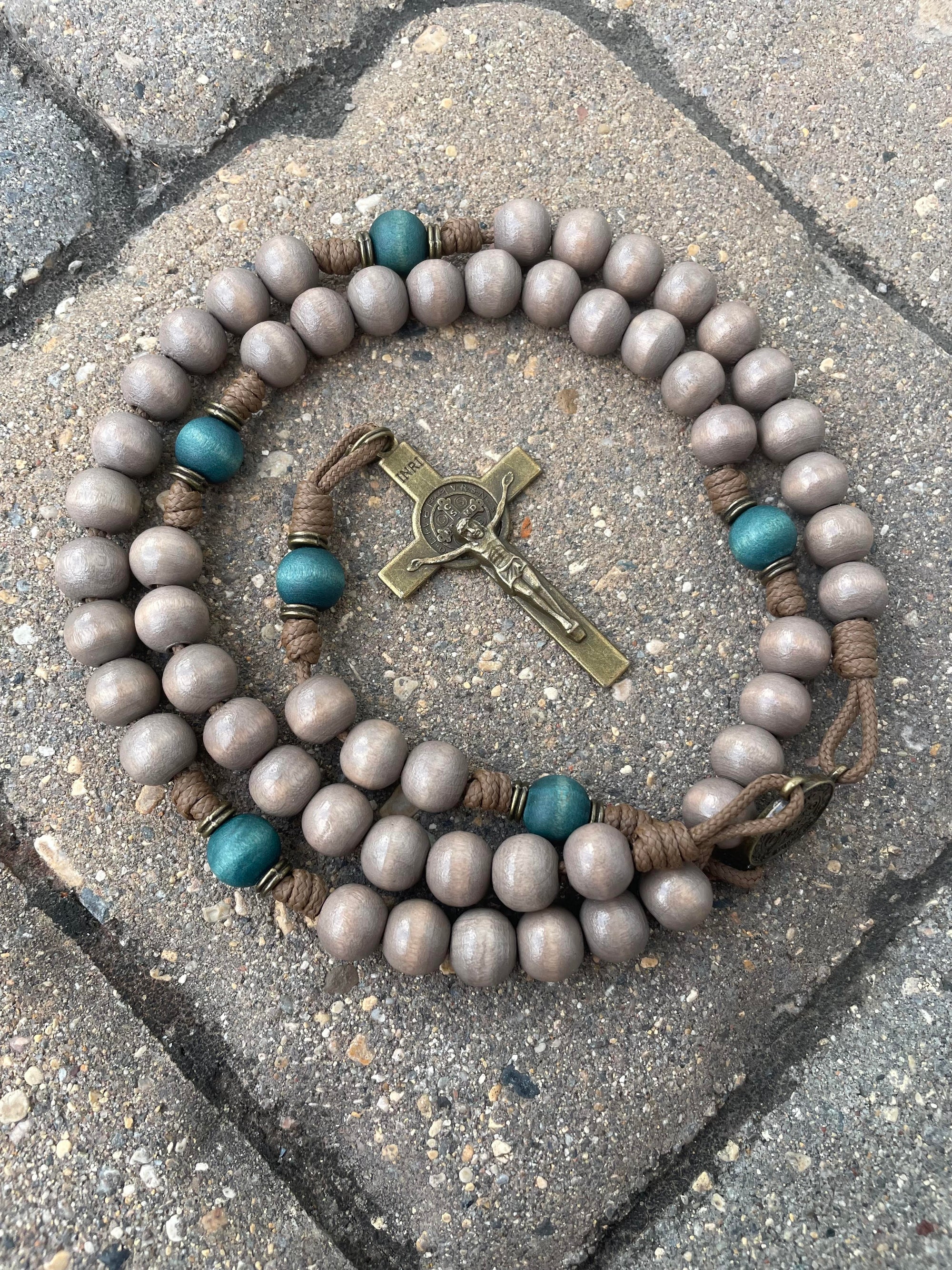 Handcrafted Noel Christmas rosary for daily prayer featuring bronze crucifix and teal-gray wood beads