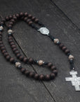 Handcrafted Padre Pio rosary for daily prayer featuring silver crucifix and walnut wood beads