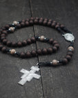 Padre Pio rosary by Runewood Rosary combining walnut wood beads, silver crucifix, and black paracord for faithful devotion