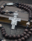 Padre Pio rosary with walnut and light gray wooden beads, silver San Damiano crucifix, and black paracord