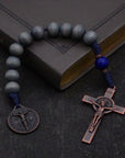 Pocket Sword of the Spirit rosary with lunar and royal blue wood beads, copper St. Benedict crucifix, and navy paracord