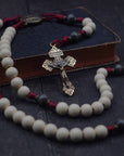 Pope Leo XIV rosary with vintage white and charcoal wooden beads, bronze Pardon crucifix, and burgundy paracord