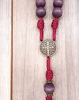 Bronze St. Benedict medal centerpiece detail on Roma Victor rosary with purple wood beads