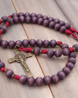 Close-up of bronze medal and paracord craftsmanship on handmade Roma Victor rosary