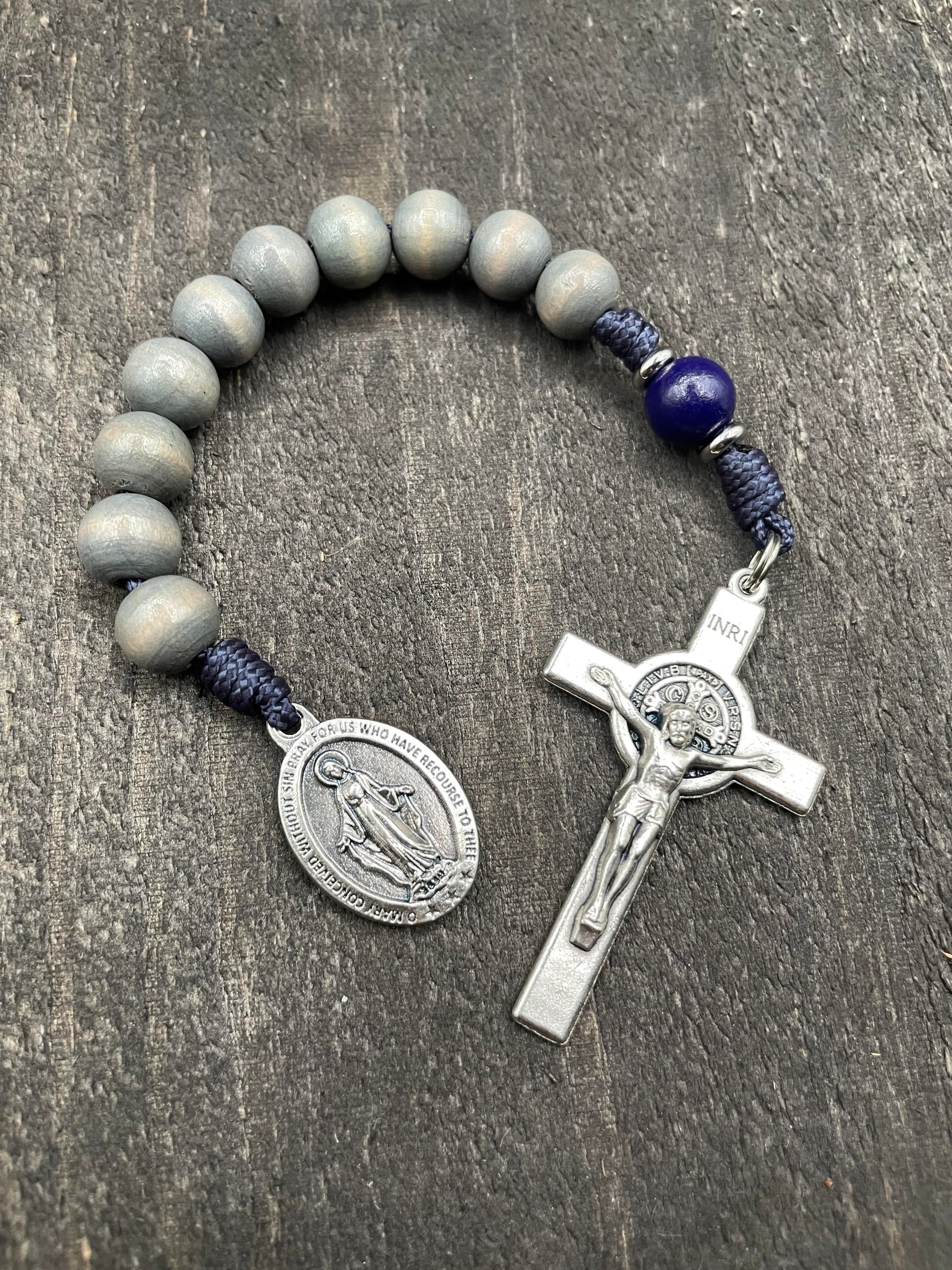 Full view of a rosary with a detailed crucifix and pendant, gray beads, and strong knots, perfect for prayer and spiritual reflection.