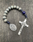 Full view of a rosary with a detailed crucifix and pendant, gray beads, and strong knots, perfect for prayer and spiritual reflection.