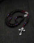 St. Carlo Acutis rosary by Runewood Rosary combining walnut wood beads, silver crucifix, and burgundy paracord for faithful devotion