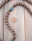 Close-up of gray-brown and teal wooden beads on St. Kateri Tekakwitha rosary showing heirloom craftsmanship