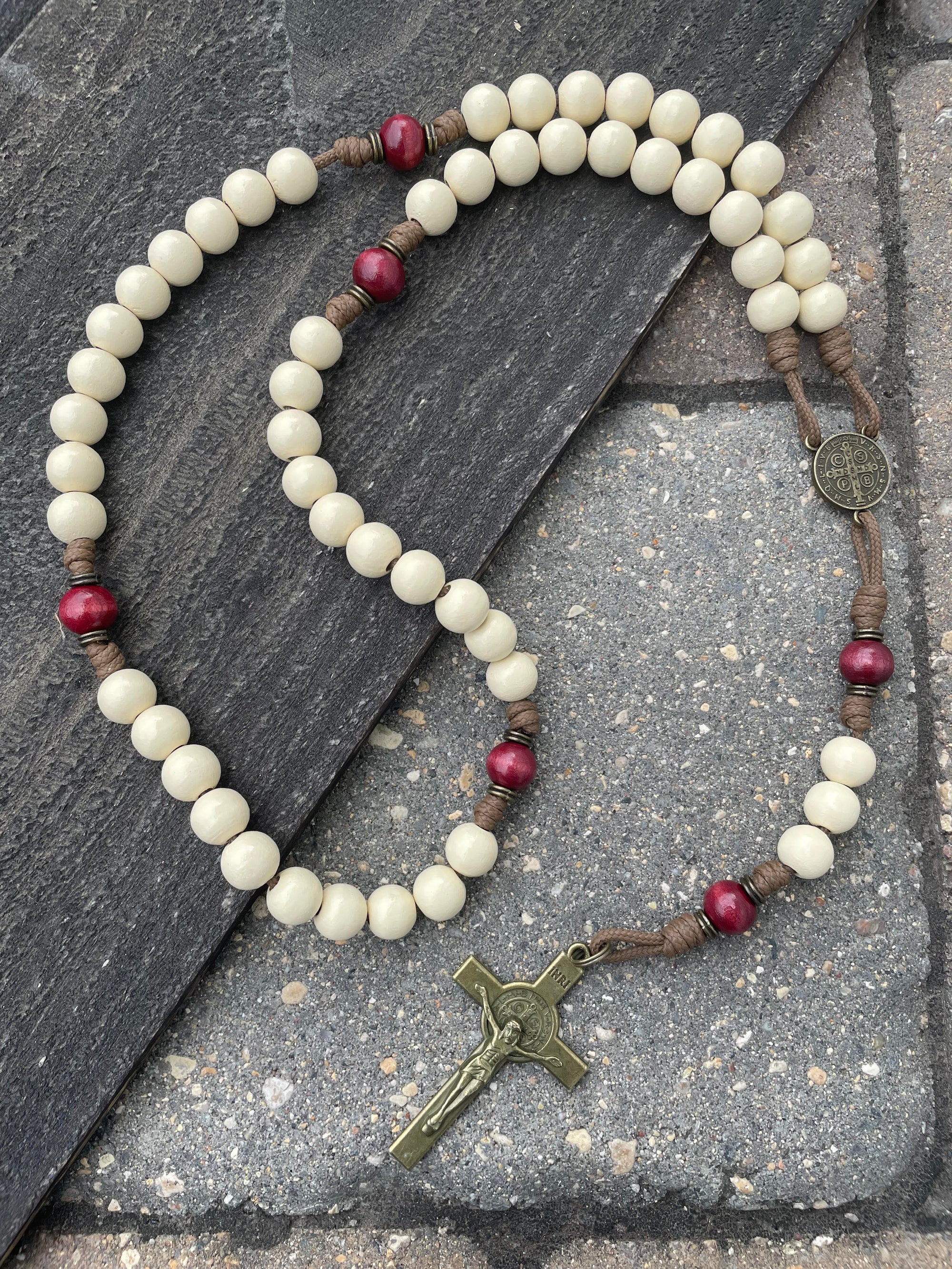 Handmade Christmas rosary featuring red and white wood beads with bronze crucifix and medal centerpiece