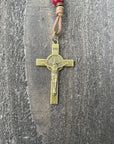 Close-up of bronze St. Benedict crucifix on St. Nicholas Christmas rosary with wood beads and paracord