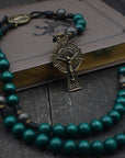 St. Patrick irish rosary with emerald green and charcoal wooden beads, bronze Celtic crucifix, and black paracord