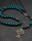 St. Patrick rosary with emerald green and charcoal wooden beads, bronze Celtic crucifix, and black paracord