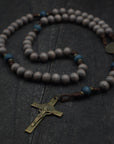Ave Maris Stella rosary with light gray and navy wooden beads, bronze St. Benedict crucifix, and walnut paracord