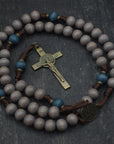 Handcrafted Ave Maris Stella rosary for daily prayer featuring bronze crucifix and gray-blue wooden beads