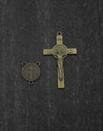 Close-up of bronze St. Benedict crucifix on Ave Maris Stella rosary with light gray and navy wood beads