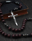 Terror of Demons rosary with purple and charcoal wooden beads, silver Nails crucifix, and durable black paracord