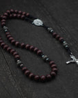 Handcrafted Terror of Demons rosary for daily prayer featuring silver crucifix and dark wooden beads