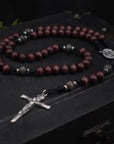 Terror of Demons rosary with purple and charcoal wooden beads, silver Nails crucifix, and durable black paracord