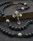 Handcrafted rosary honoring Pope Leo XIV featuring charcoal wood beads, bronze crucifix, and Miraculous Medal centerpiece
