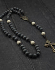Augustinian rosary with charcoal and white wooden beads, bronze Pardon crucifix, and acid brown paracord