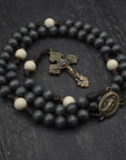 Augustinian rosary by Runewood Rosary combining charcoal and white wood beads, bronze crucifix, and paracord for faithful devotion