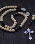 Handcrafted rosary honoring St. Teresa of Ávila featuring cream Hail Mary beads, black Our Father beads, and silver crucifix