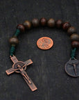 Handmade pocket rosary featuring gray-brown stained beads, copper crucifix, and emerald green paracord
