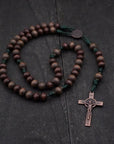 Handmade paracord rosary featuring gray and brown wood beads with copper crucifix and bronze bead caps