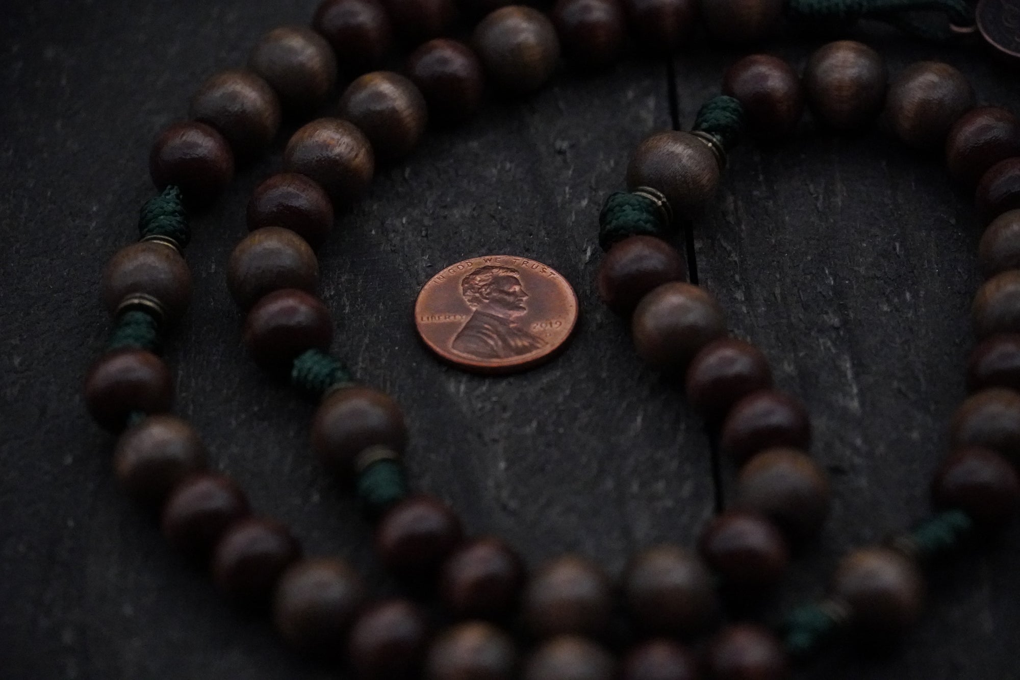 Close-up of gray and brown wooden beads on The Woodsman rosary showing heirloom craftsmanship