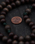 Close-up of gray and brown wooden beads on The Woodsman rosary showing heirloom craftsmanship
