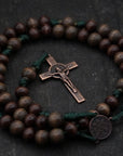 Close-up of copper St. Benedict medal and paracord craftsmanship on handmade rosary