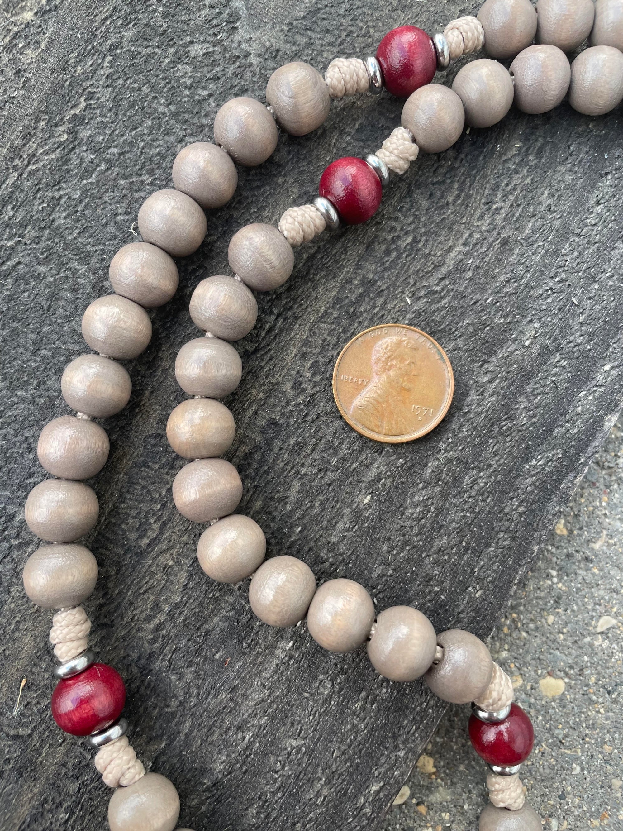 Close-up of red and light gray stained wooden beads on Bethlehem Christmas rosary