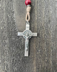 Close-up of oxidized silver medal and paracord detail on handcrafted wooden christmas rosary
