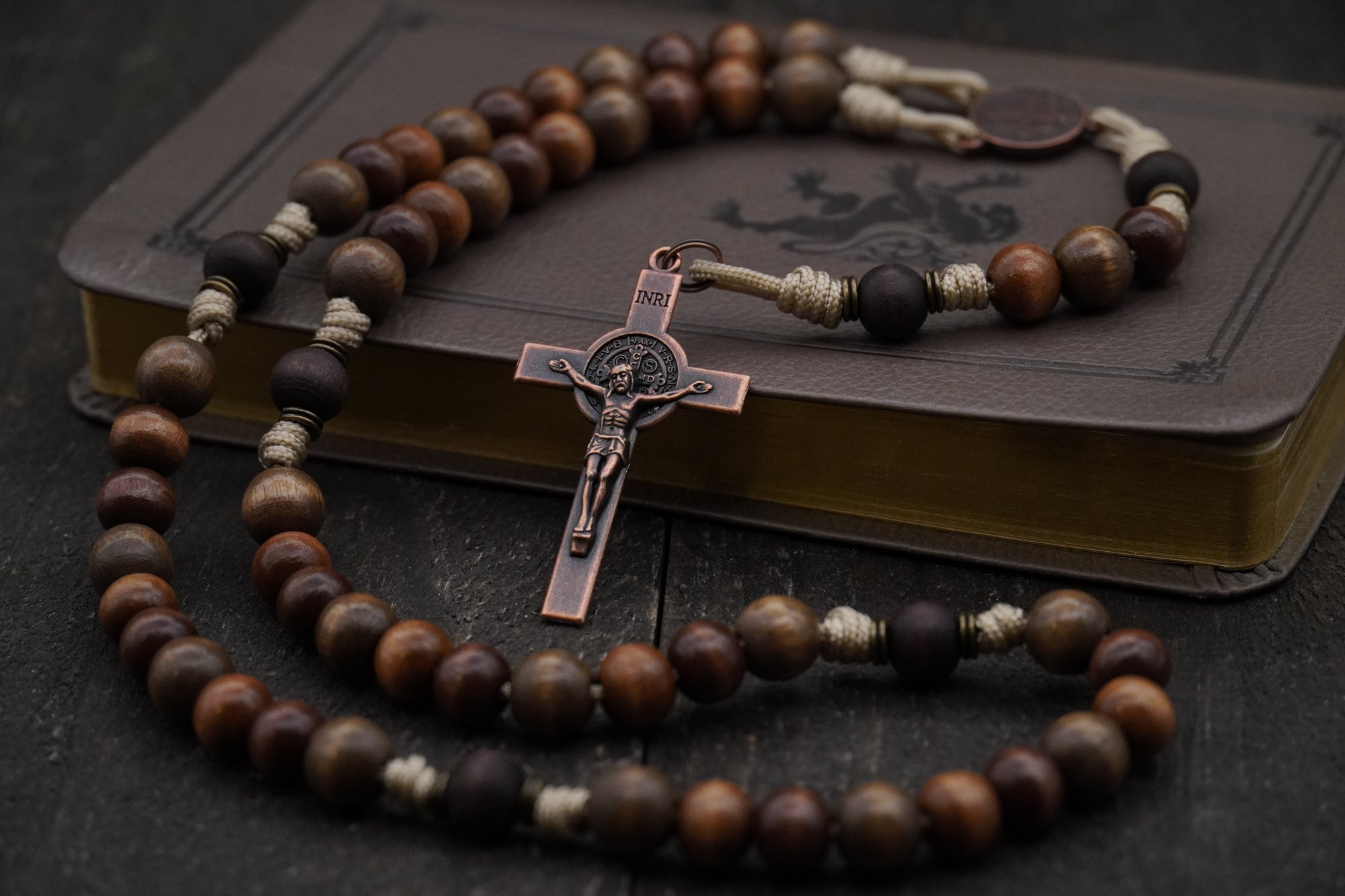 Handcrafted wooden rosary with desert tan paracord and copper St. Benedict crucifix