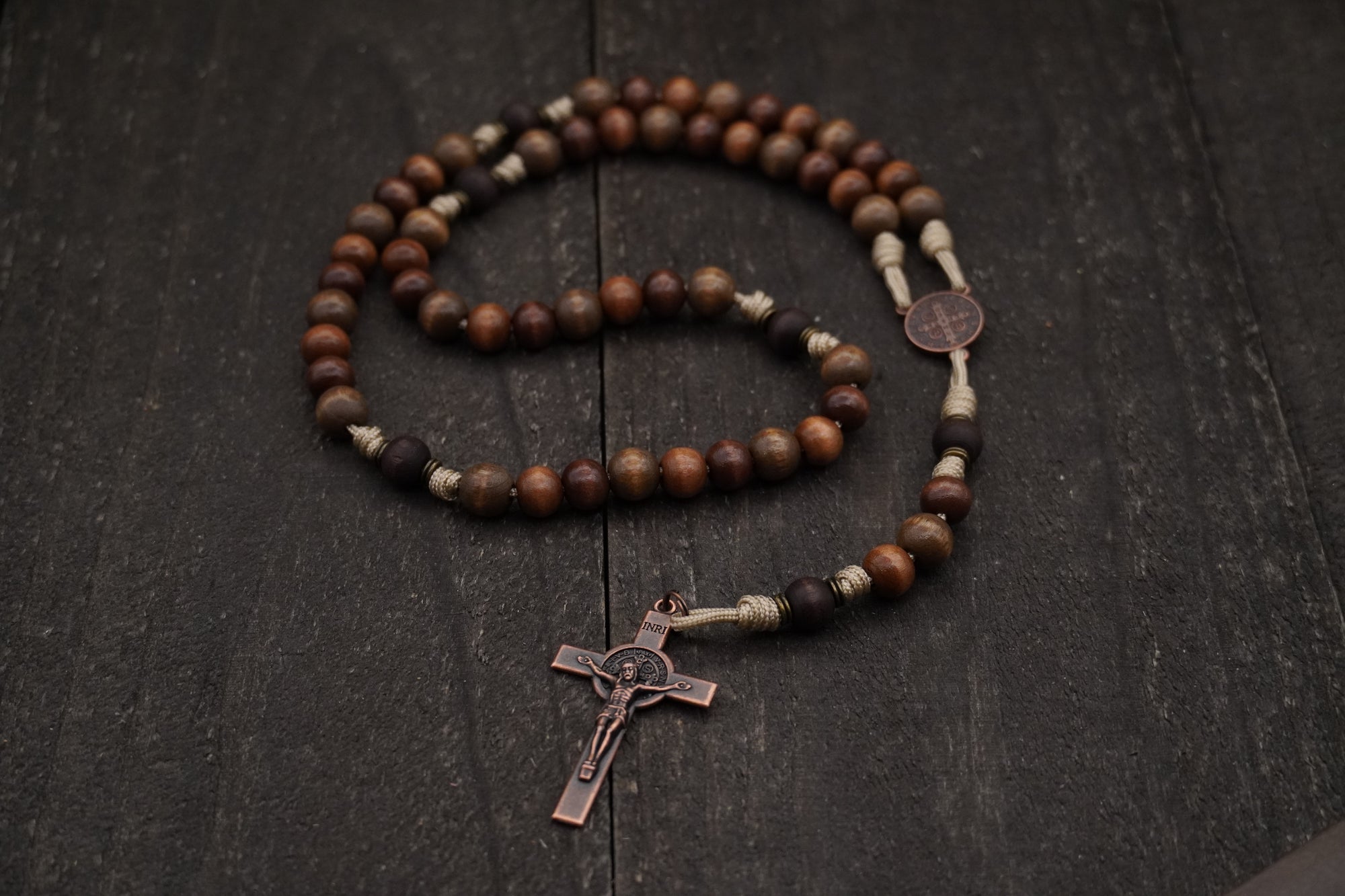 Handcrafted wooden rosary with desert tan paracord and copper St. Benedict crucifix