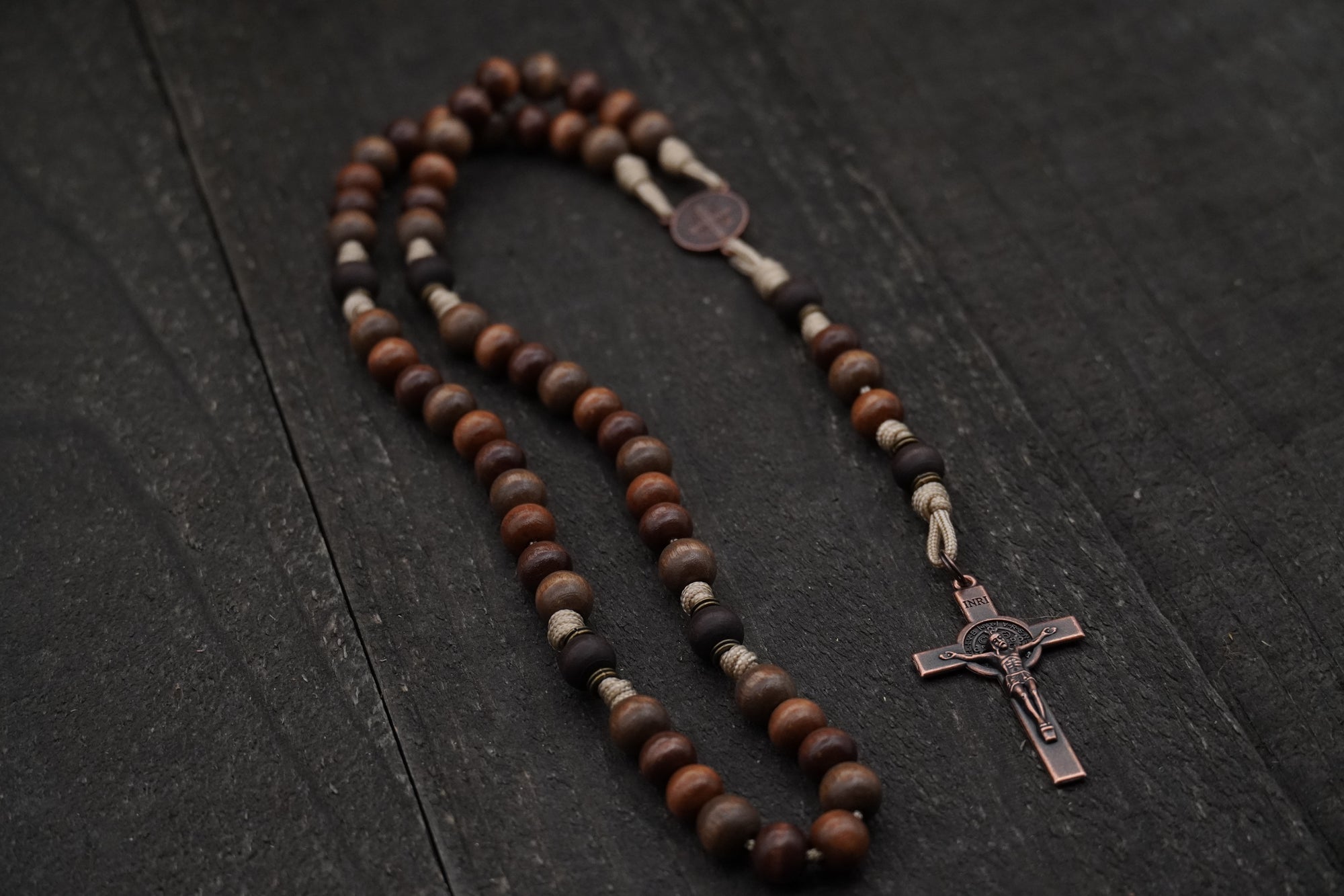 Handcrafted wooden rosary with desert tan paracord and copper St. Benedict crucifix
