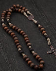 Handcrafted wooden rosary with desert tan paracord and copper St. Benedict crucifix