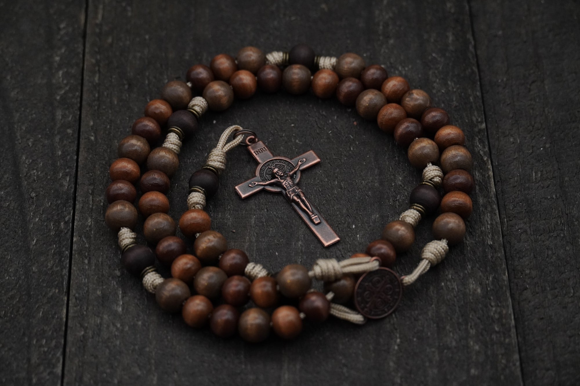 Handcrafted wooden rosary with desert tan paracord and copper St. Benedict crucifix