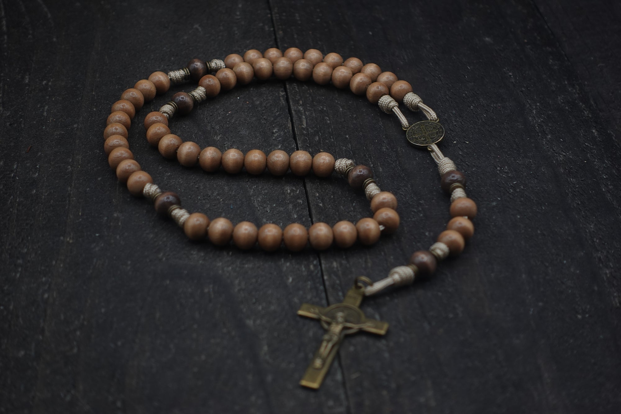 Bronze St. Benedict crucifix and medal centerpiece on durable tan paracord rosary built for daily prayer