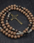Road to Damascus paracord rosary with tan and gray-brown wooden beads and bronze St. Benedict crucifix, handcrafted in Fargo ND